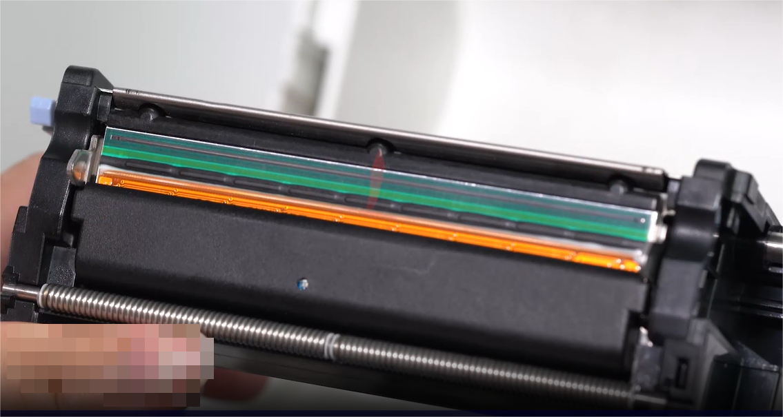 एक close-up of a person carefully cleaning an electronic component with a swab.